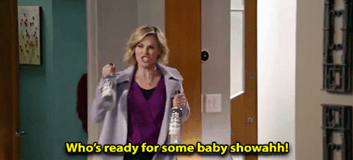 Claire Dunphy holding bottles in a celebratory baby shower scene
